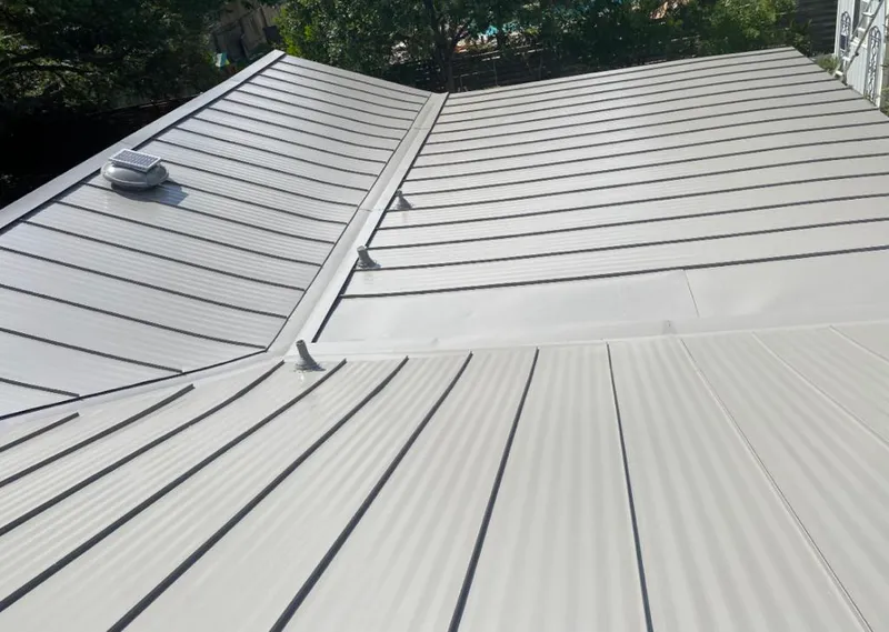 Solar attic fan installed on a metal roof for Roof Ventilation in Coal